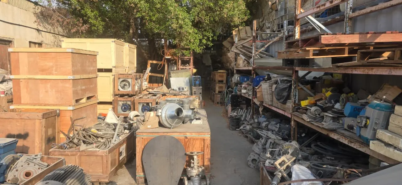 Warehouse yard stacked with surplus stock and equipment awaiting valuation